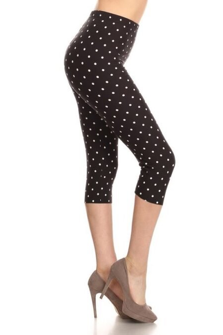 high waisted capri leggings with an elastic band in a white polka dot print over a black background