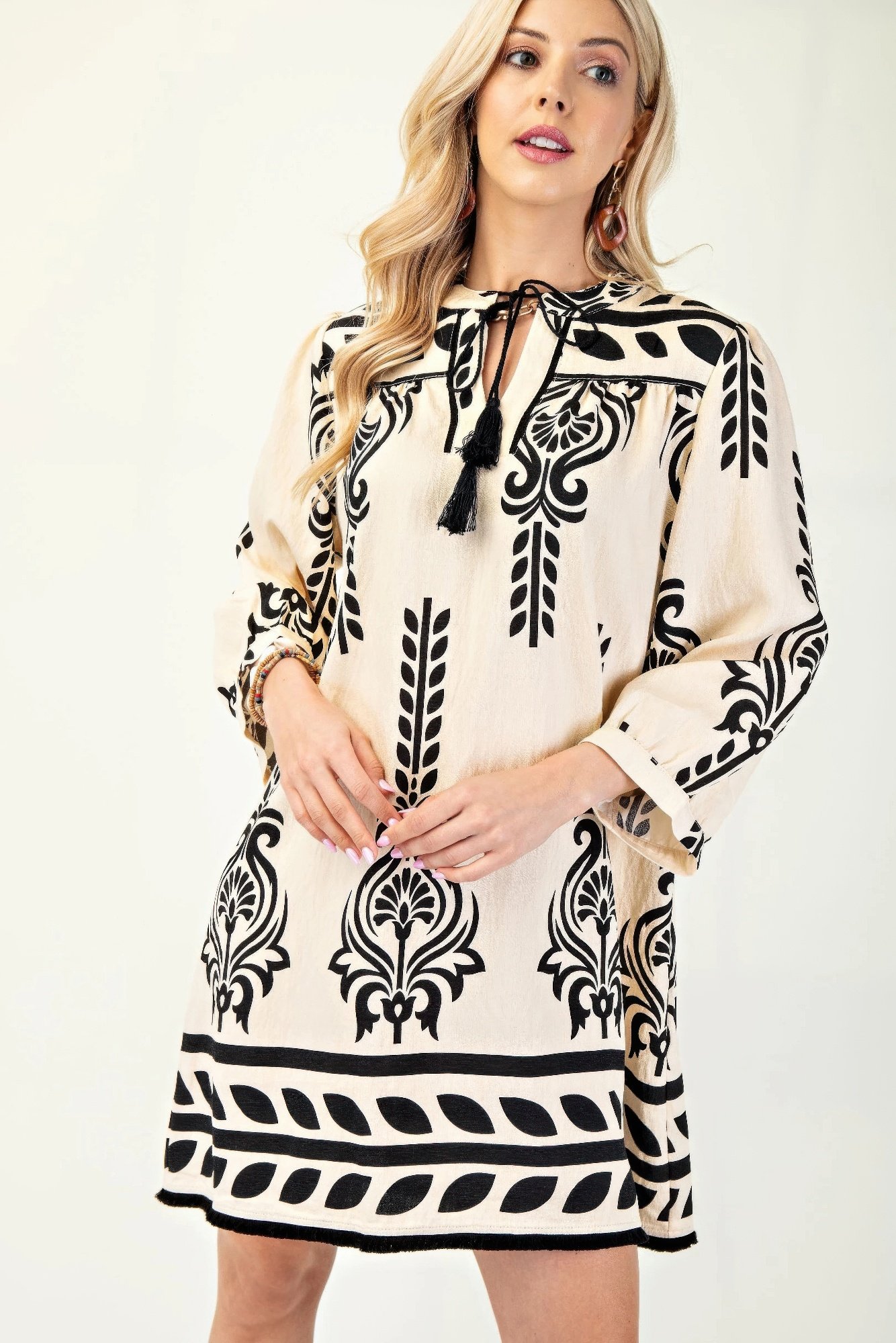 printed 3/4 sleeve dress with tassel tie and fringe detail on hem